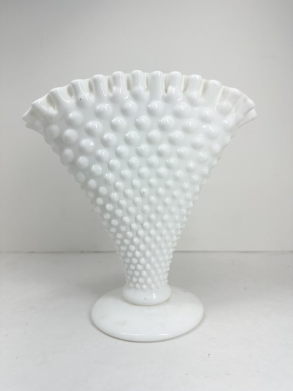 HOBNAIL MILK GLASS FAN VASE MID-CENTURY: A mid-century fan-shaped vase in opaque white milk glass featuring a crimped, ruffled rim and an all-over hobnail pattern. The vessel is supported by a circular pedestal foot.