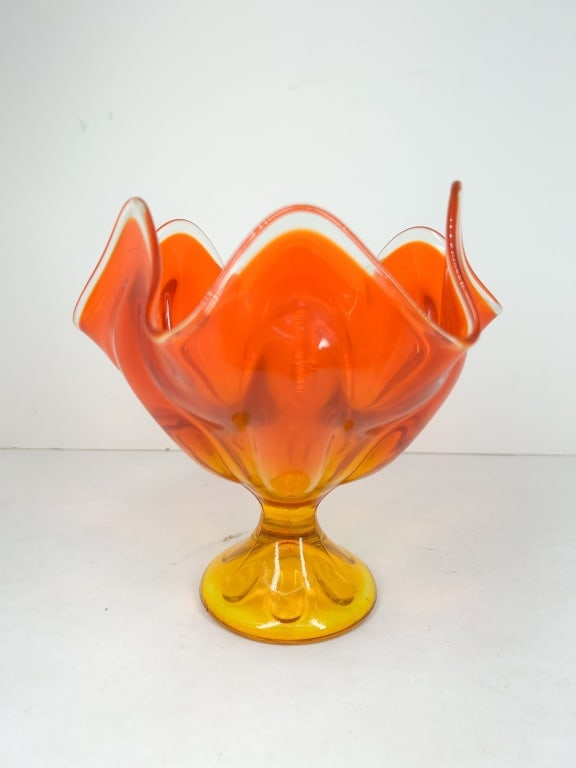 MCM AMBERINA CASED GLASS PEDESTAL BOWL: A mid-century modern cased art glass pedestal bowl featuring a six-point swung rim. The vessel displays a graduated color transition from a vibrant orange-red rim to a golden-yellow pedestal base.