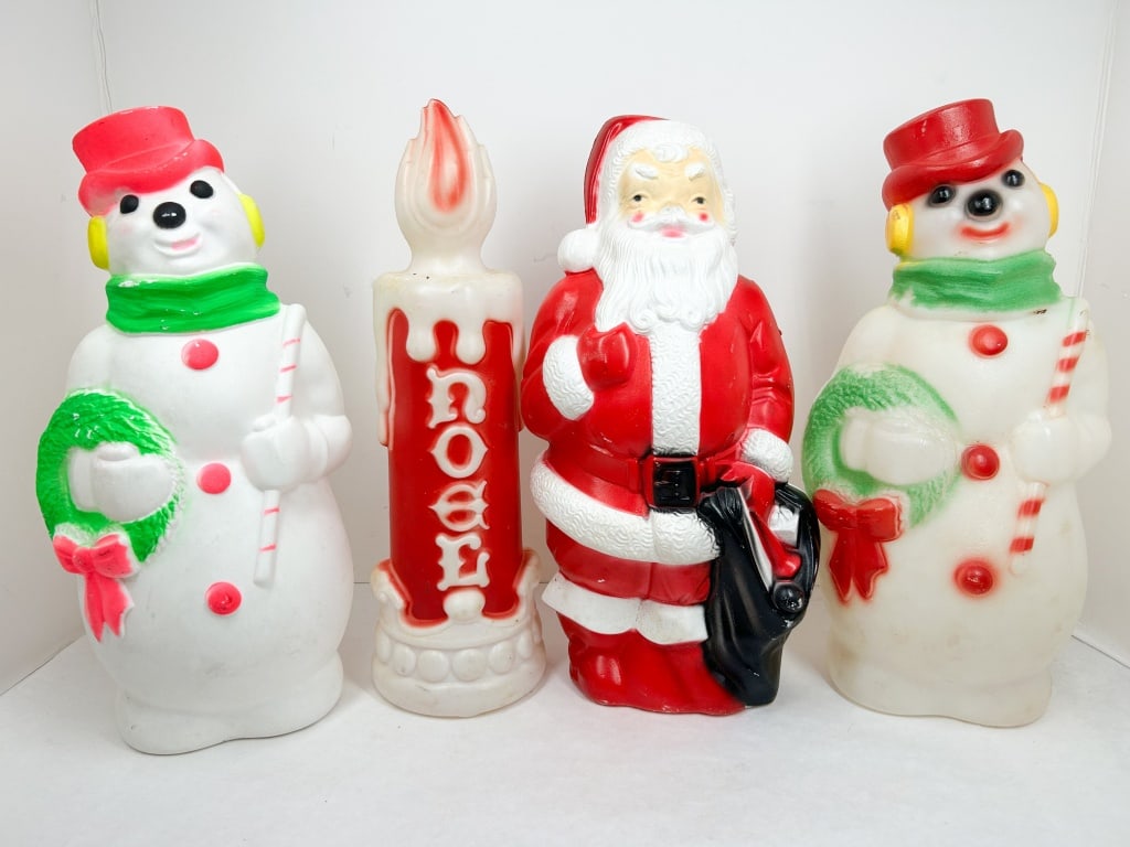FOUR VINTAGE EMPIRE BLOW MOLDS: A collection of four vintage blow-molded plastic tabletop holiday decorations produced by Empire Plastic Corp. A yellow circular adhesive label on the reverse of the candle reads EMPIRE and MADE IN