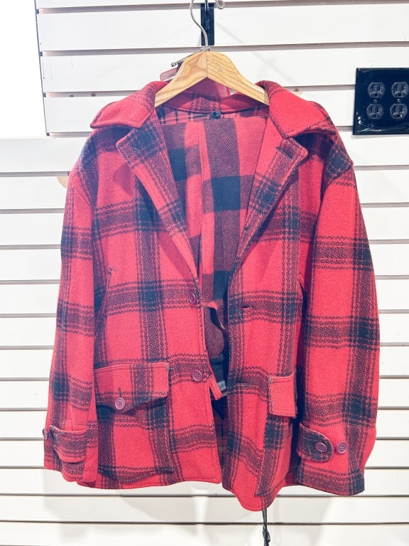 HETTRICK MFG. CO. WOOL HUNTING SET, CIRCA 1950: A vintage two-piece hunting suit comprising a Mackinaw jacket and matching trousers in red and black Buffalo plaid wool. The jacket features a wide collar, adjustable buttoned wrist straps, and a rear