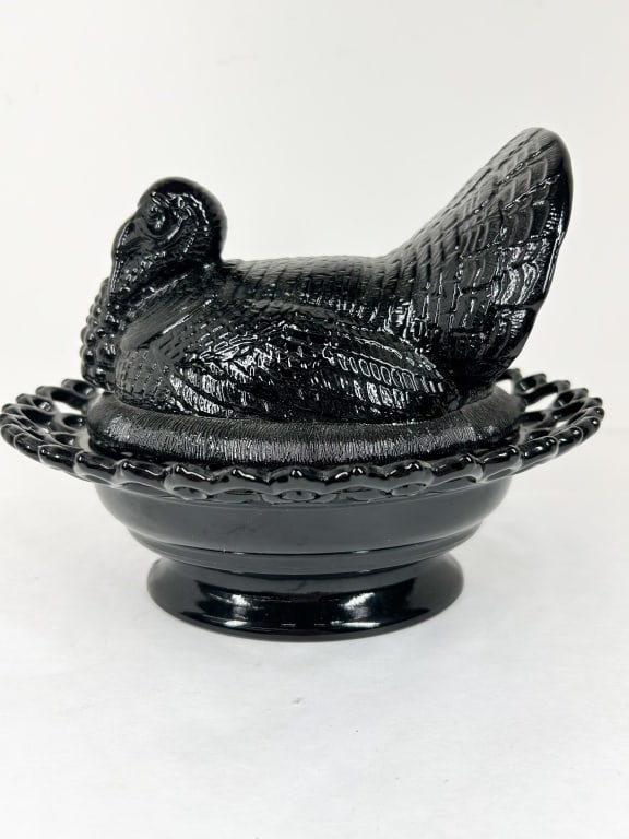 MOSSER BLACK AMETHYST GLASS TURKEY ON NEST: A black amethyst glass covered turkey on nest candy dish. The two-piece set features a lid molded as a tom turkey with a fanned tail and a base with an open-lace lattice rim.