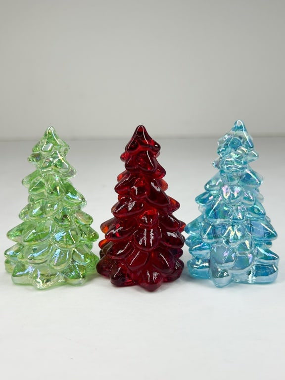 MOSSER TRIO OF IRIDESCENT GLASS CHRISTMAS TREES: A trio of molded glass holiday trees featuring a textured, tiered branch design. The set includes one light green and one light blue tree, both with an iridescent aurora borealis finish, and one deep 