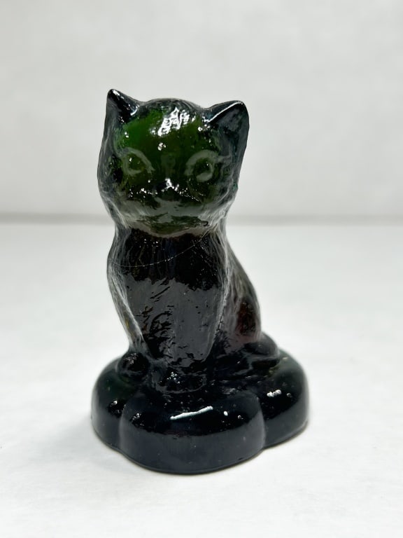 BOYD BLACK SITTING KITTEN ON PILLOW: A molded black glass kitten figurine produced by Boyd Crystal Art Glass. The underside of the scalloped base features an embossed diamond mark containing the letter B. The glass appears opaque black u