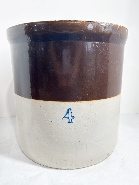 TWO-TONE FOUR GALLON STONEWARE CROCK: American utilitarian stoneware crock featuring a cylindrical form with a flared rim and shoulder. The exterior is finished with a dark brown Albany-type slip glaze on the upper third and a light gray 
