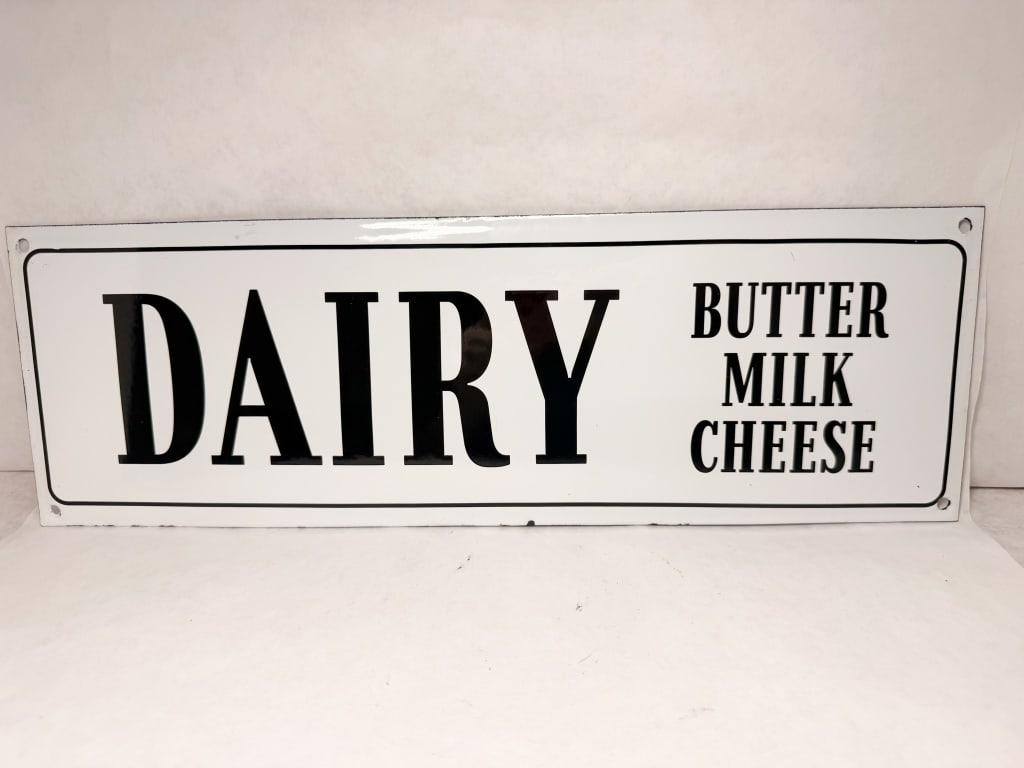 SS METAL DAIRY SIGN: advertising sign for a retail storefront or dairy counter. The front features black high-contrast lettering on a white ground with a thin black border, displaying the text DAIRY, BUTTER, MILK, and CHE