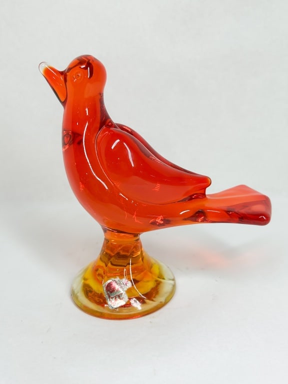 VIKING AMBERINA GLASS BIRD FIGURINE: Mid-Century Modern hand-blown glass figurine of a bird in the Amberina colorway, transitioning from persimmon red to yellow. A worn silver foil label is applied to the base, featuring a red stylized m