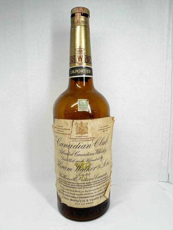 CANADIAN CLUB ONE GALLON DISPLAY BOTTLE, 1946: A vintage large-format amber glass display bottle for Canadian Club Blended Canadian Whisky. The main paper label reads "Canadian Club Blended Canadian Whisky Distilled and Blended by Hiram Walker & S