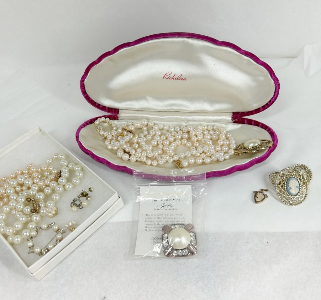 RICHELIEU AND FRANKLIN MINT COSTUME JEWELRY: An assortment of mid-century and vintage costume jewelry featuring a Richelieu multi-strand faux pearl necklace with a large gold-tone floral clasp set with a blister pearl, housed in its original