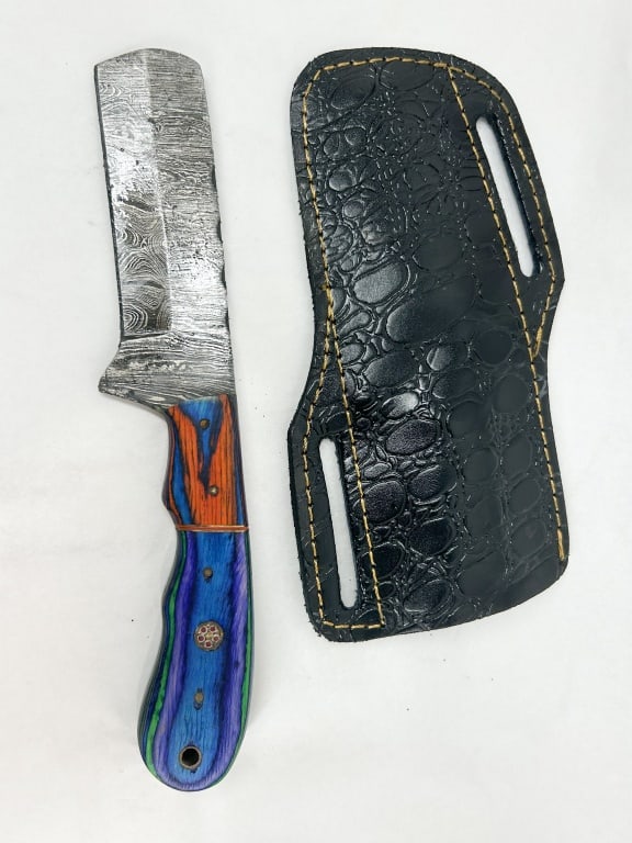 DAMASCUS STEEL CLEAVER HUNTER WITH LAMINATE HANDLE: A fixed-blade cleaver-style hunting knife featuring a pattern-welded Damascus steel blade with a brute de forge finish. The full tang is fitted with multi-colored blue, green, and orange stabilized la
