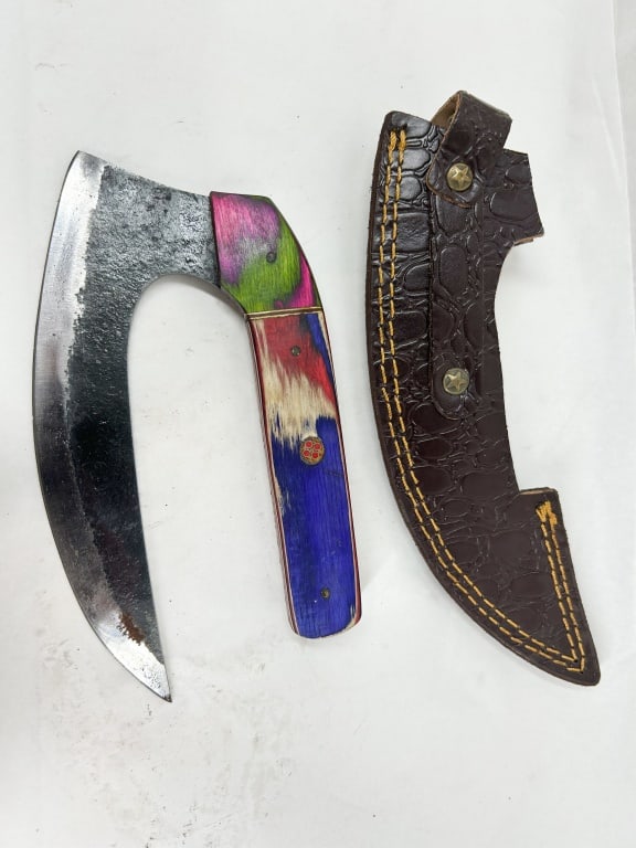 DAMASCUS CRESCENT BLADE SKINNING KNIFE WITH LEATHER SHEATH: A contemporary fixed-blade skinning knife featuring a carbon steel crescent blade with a forge-finished spine and polished primary grind. The full tang is fitted with multi-colored stabilized wood sca