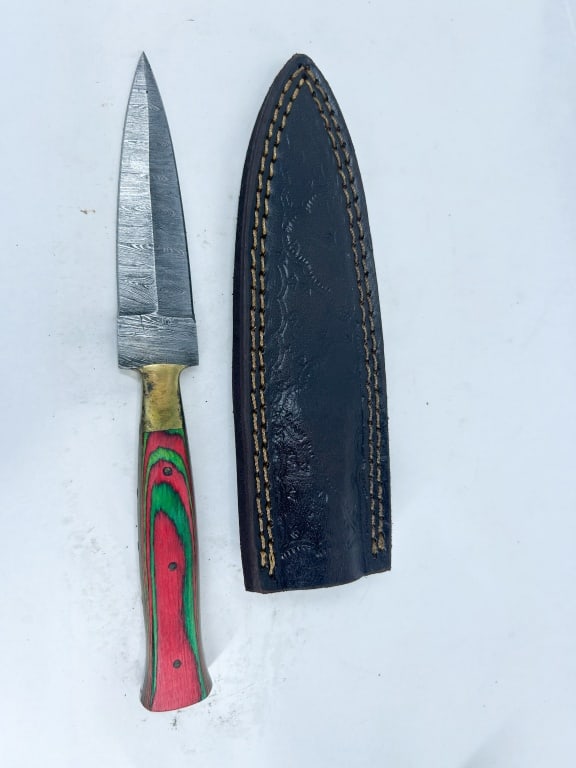 DAMASCUS STEEL AND PAKKAWOOD DAGGER: A double-edged spear point dagger featuring a pattern-welded Damascus steel blade and a full tang construction. The handle consists of red and green laminated pakkawood scales secured by three brass p