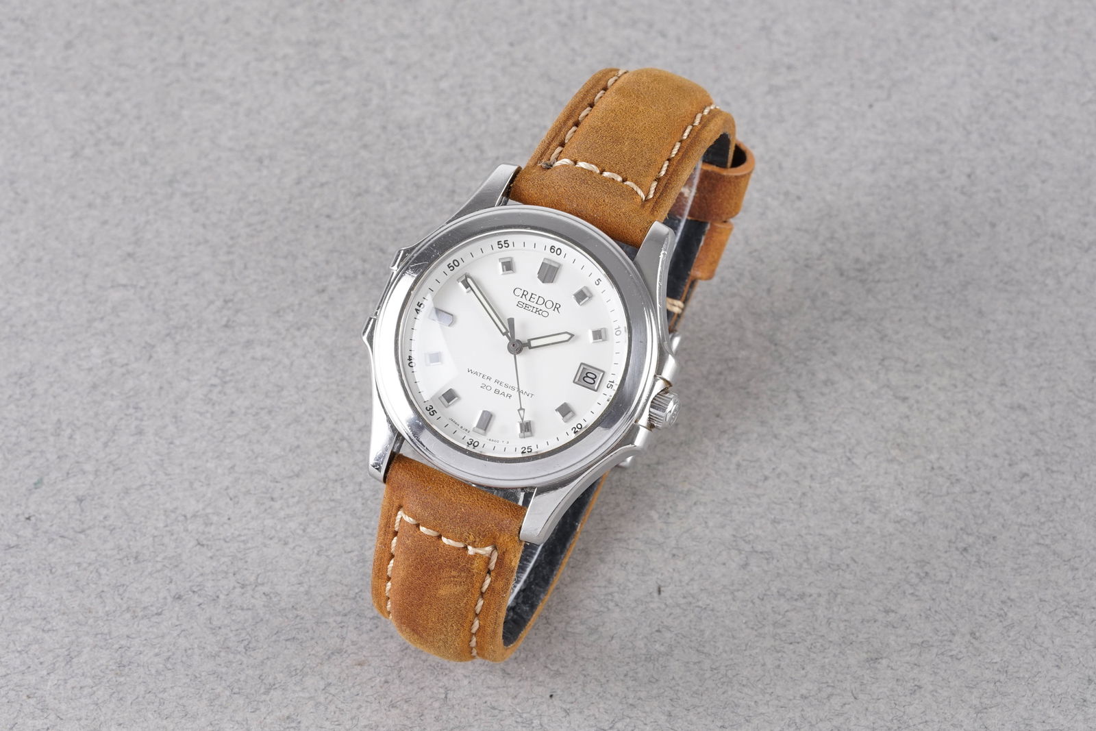 CREDOR SEIKO DATE WRISTWATCH REF. 8J82-6A00: CREDOR SEIKO DATE WRISTWATCH REF. 8J82-6A00, this watch is a ref. 8J82-6A00 and is fitted with a circular white dial with applied block hour markers and hands. The 43mm stainless steel case is