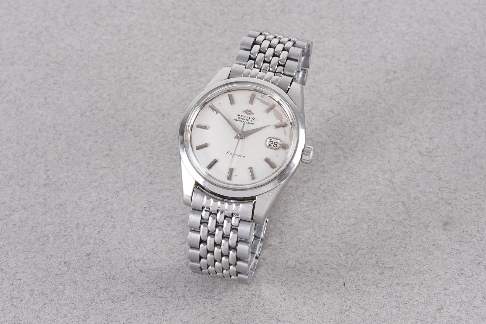 MOVADO QUICK DATE TRANS ATLANTIC KINGMATIC: MOVADO QUICK DATE TRANS ATLANTIC KINGMATIC, this watch is fitted with a circular dial with a date window, applied hour markers and dauphine hands. The 36mm stainless steel case is fitted with it