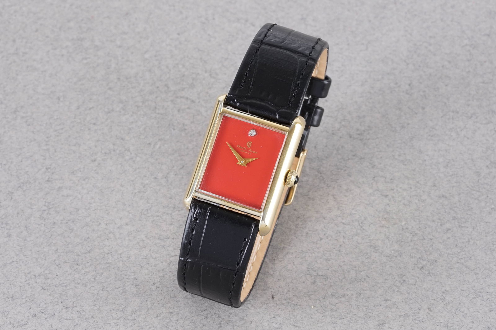 CHARLES ANDRE TANK GENEVE GOLD PLATED WRISTWATCH: CHARLES ANDRE TANK GENEVE GOLD PLATED WRISTWATCH, this watch is fitted with a rectangular red dial with a 12 o'clock hour markers and dauphine hands. The 23x32mm case is fitted with a crown and a