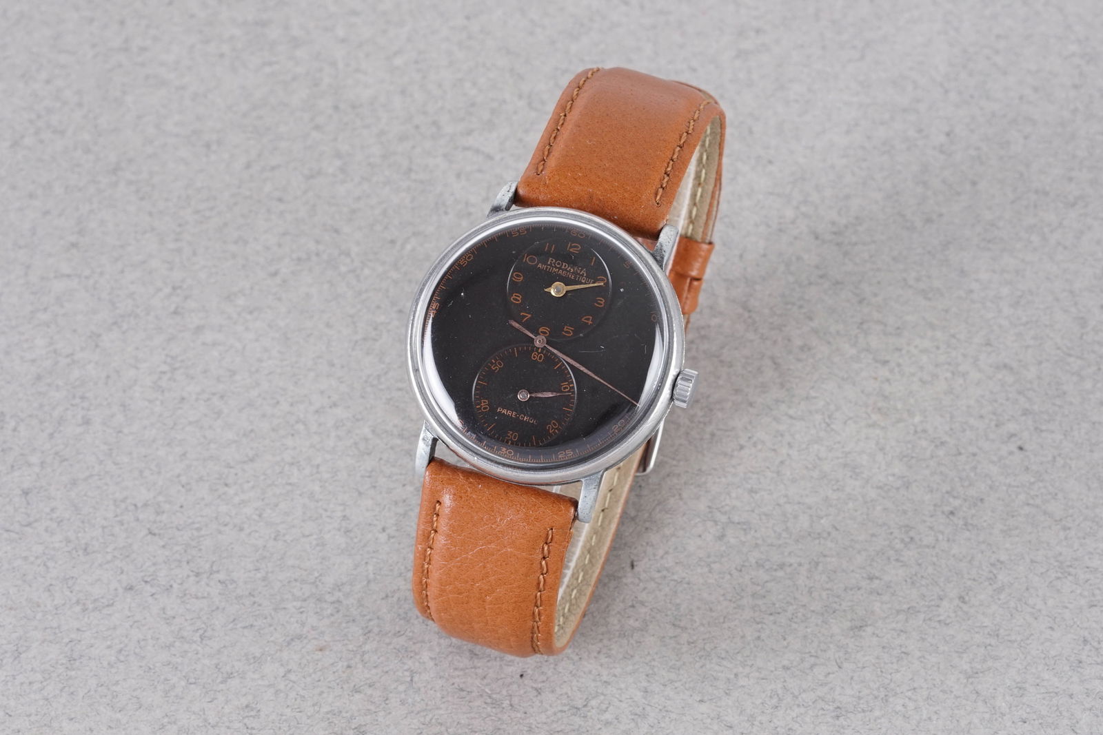 RODANA ANTI-MAGNETIC REGULATOR DOCTORS WRISTWATCH: RODANA ANTI-MAGNETIC REGULATOR DOCTORS WRISTWATCH, this watch is fitted with a circular black dial with hour markers and hands. The 34mm stainless steel case is fitted with a crown and a case back. In