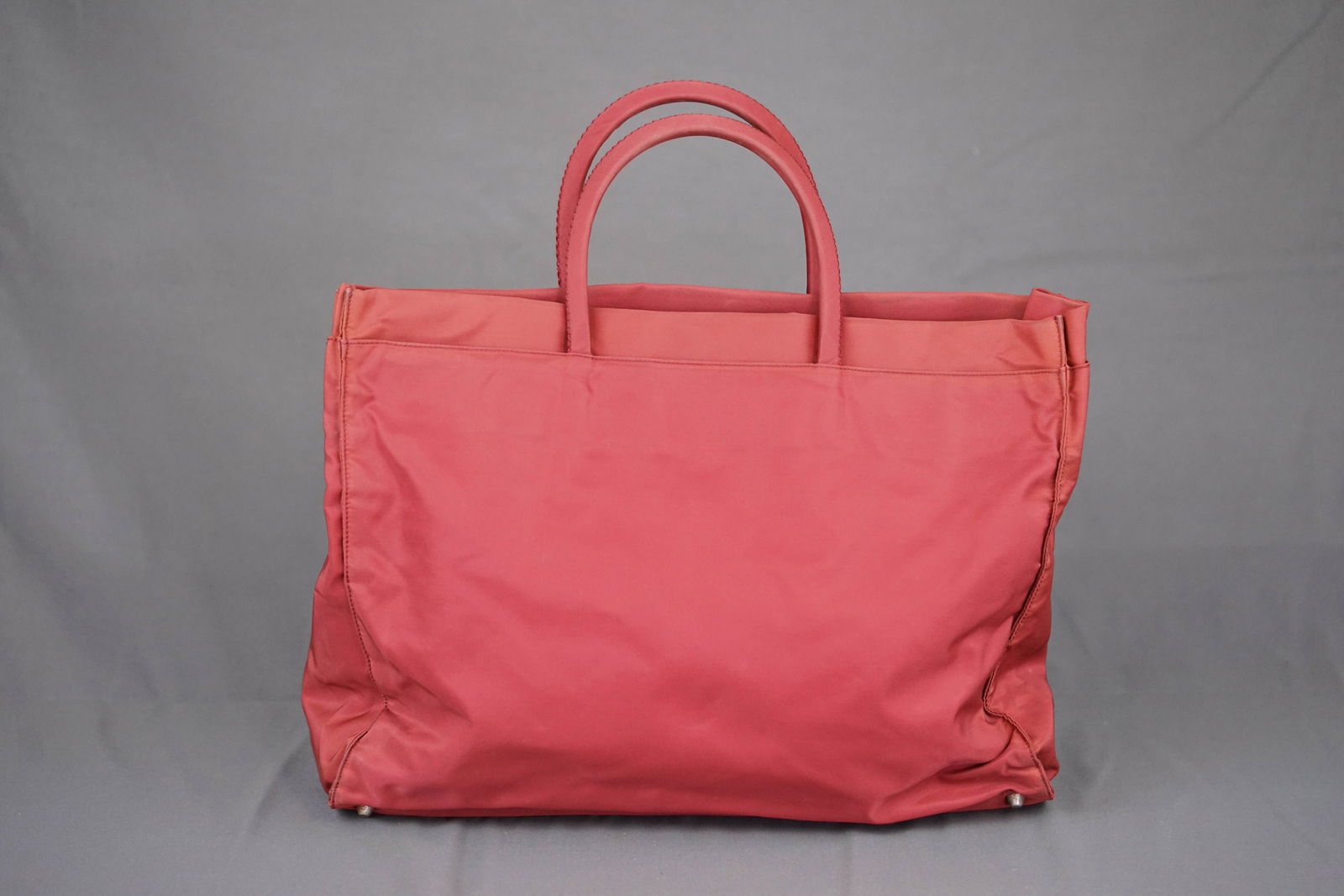 PRADA LARGE RED HANDBAG: PRADA LARGE RED HANDBAG, nylon, width 39cm, height 31cm, depth 10cm. PLEASE NOTE: *This lot is elected for VAT (20%) on the hammer which will not apply for successful bidders outside of the UK