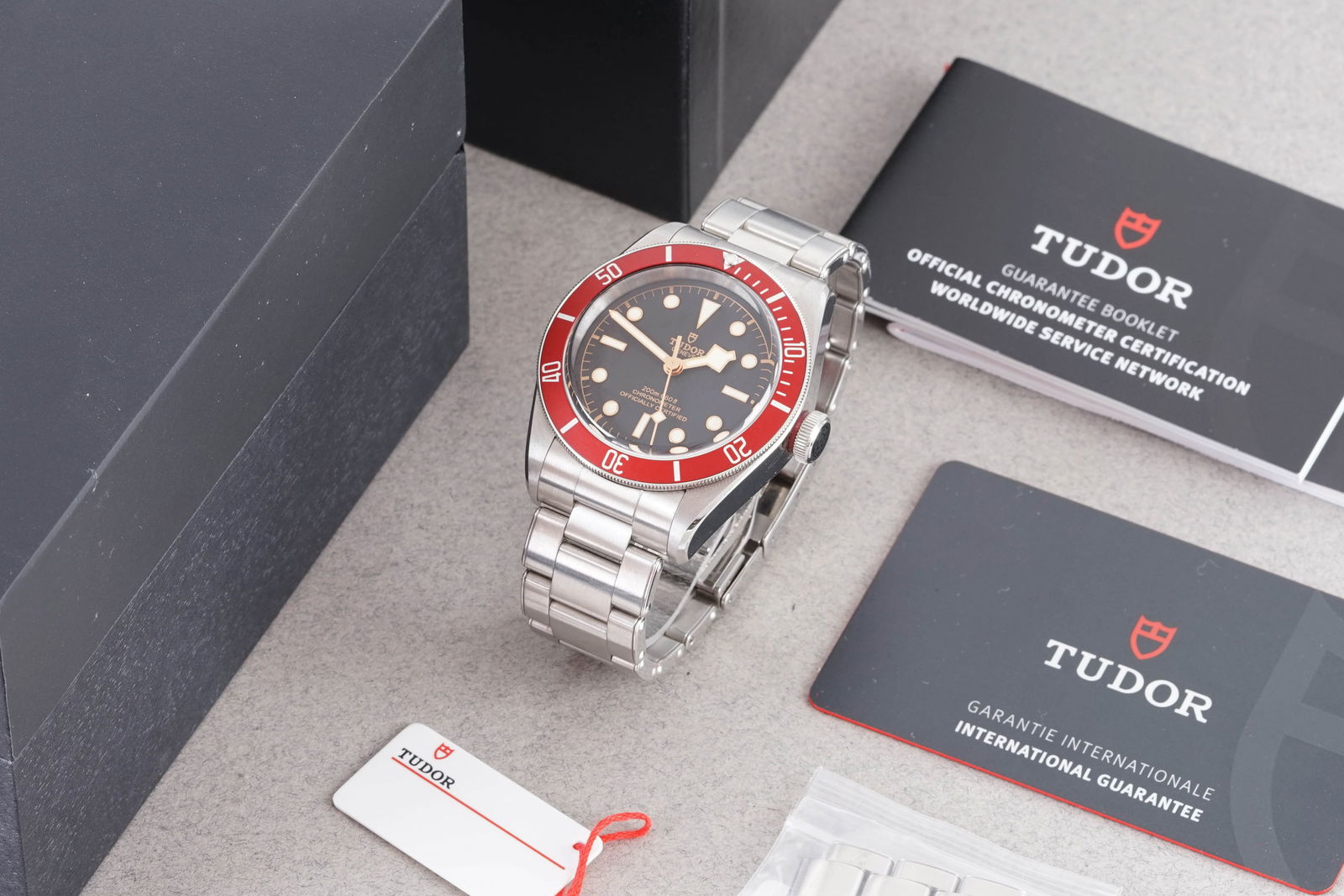 TUDOR BLACK BAY W/ BOX & GUARANTEE PAPERS REF. 79230R CIRCA 2022: TUDOR BLACK BAY W/ BOX & GUARANTEE PAPERS REF. 79230R CIRCA 2022, this watch is a ref. 79230R and is fitted with a circular black dial with lume plot hour markers and hands. The 41mm stainless