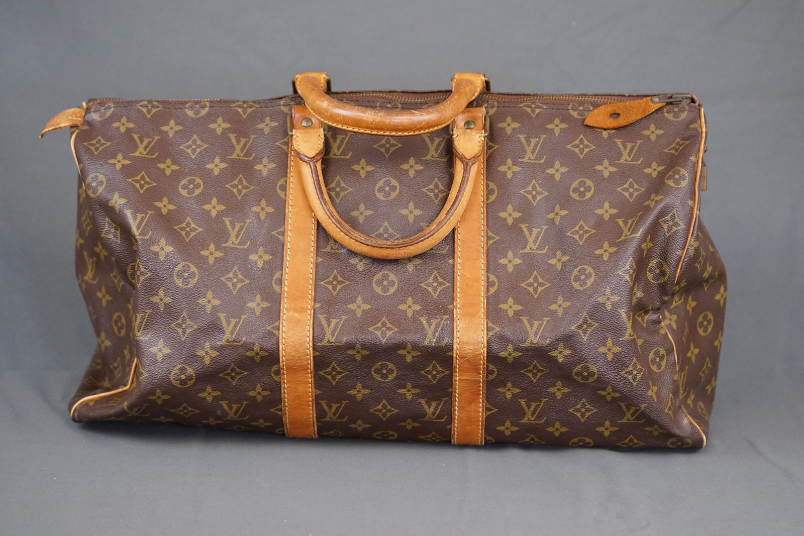 LOUIS VUITTON MONOGRAM BOSTON BAG HOLDALL M41426: LOUIS VUITTON MONOGRAM BOSTON BAG M41426, width 50cm, height 28cm, depth 22cm. PLEASE NOTE: *This lot is elected for VAT (20%) on the hammer which will not apply for successful bidders outside of the