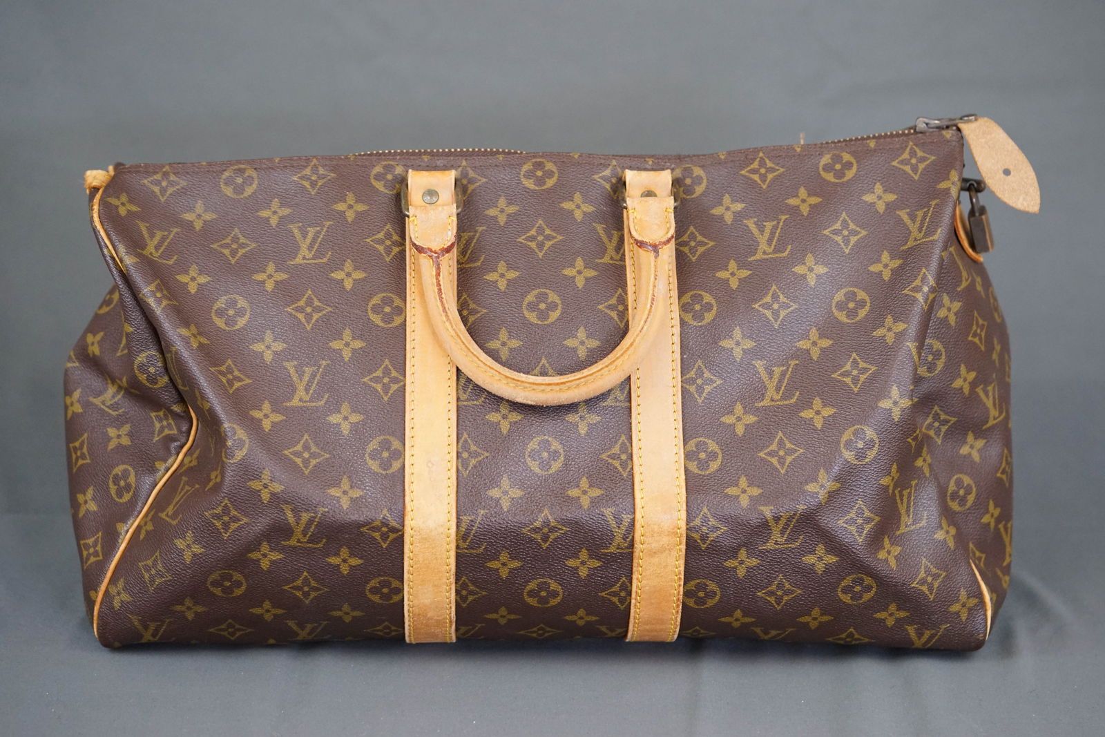 LOUIS VUITTON MONOGRAM BOSTON BAG HOLDALL M41428: LOUIS VUITTON MONOGRAM BOSTON BAG HOLDALL M41428, width 45cm, height 26cm, depth 20cm. PLEASE NOTE: *This lot is elected for VAT (20%) on the hammer which will not apply for successful bidders