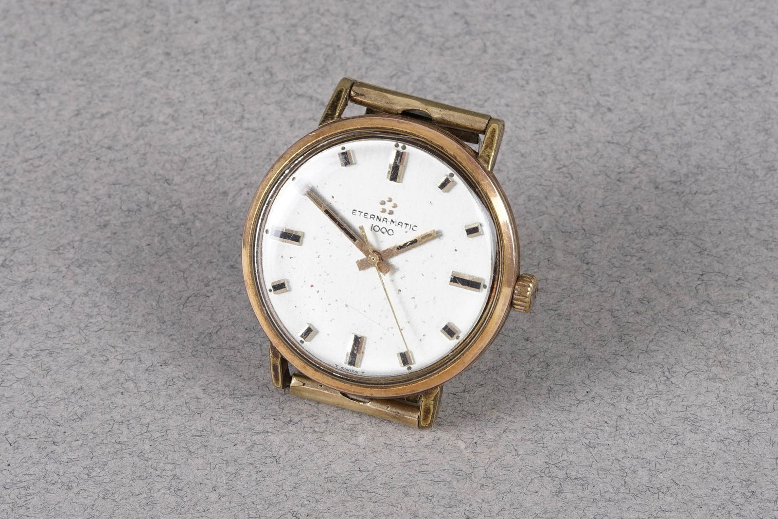 ETERNA-MATIC 1000 GOLD PLATED WRISTWATCH: ETERNA-MATIC 1000 GOLD PLATED WRISTWATCH, this watch is fitted with a circular patina dial with applied hour markers and hands. The 34mm gold plated case is fitted with a crown and a case back.
