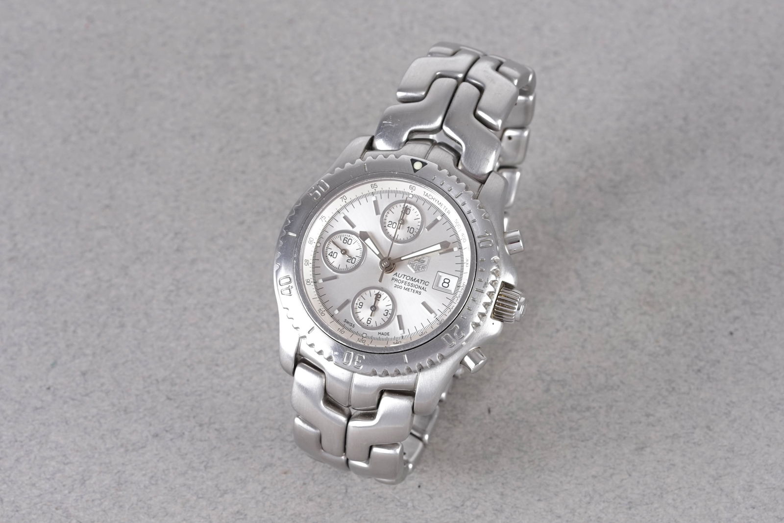 TAG HEUER LINK AUTOMATIC CHRONOGRAPH REF. CT2113: TAG HEUER LINK AUTOMATIC CHRONOGRAPH REF. CT2113, this watch is a ref. CT2113 and is fitted with a circular silver triple register dial with applied stick hour markers and hands. The 41mm stainless st