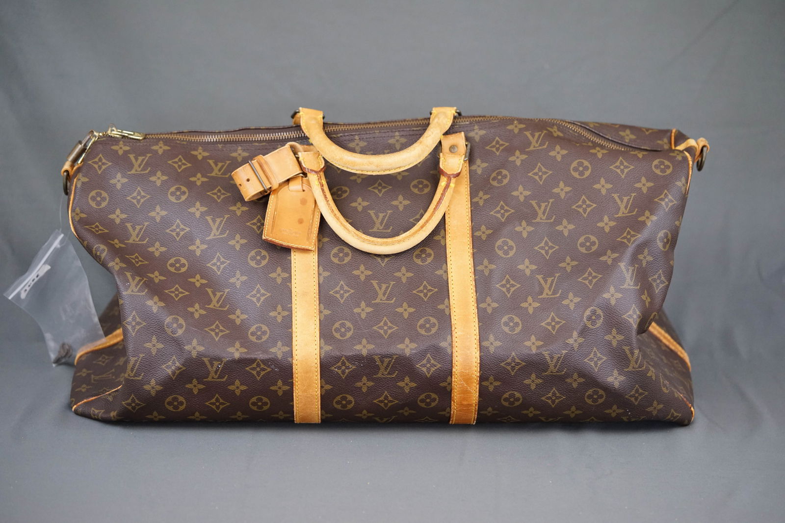 LOUIS VUITTON MONOGRAM BOSTON BAG HOLDALL M41412: LOUIS VUITTON MONOGRAM BOSTON BAG HOLDALL M41412, width 60cm, height 32cm, depth 26cm. PLEASE NOTE: *This lot is elected for VAT (20%) on the hammer which will not apply for successful bidders