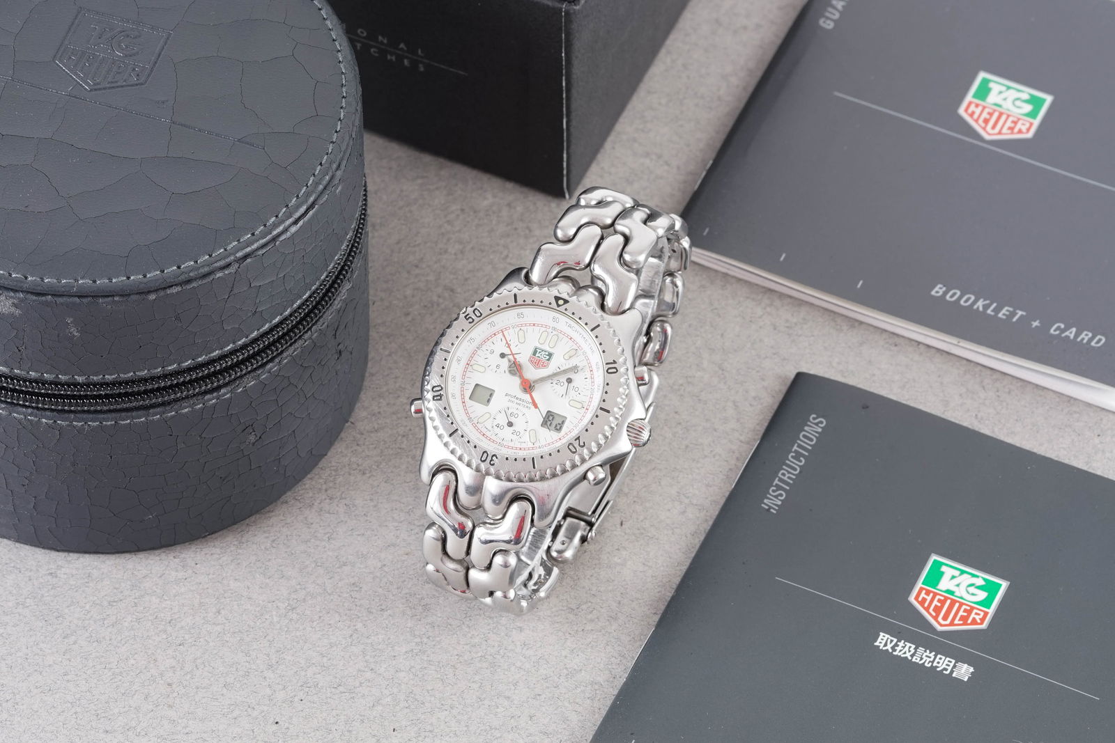 TAG HEUER CELL PROFESSIONAL CHRONOGRAPH REF. CG1111-0: TAG HEUER CELL PROFESSIONAL CHRONOGRAPH REF. CG1111-0, this watch is a ref. CG1111-0 and is fitted with a circular triple register white dial with hour markers and hands. The 38mm stainless steel