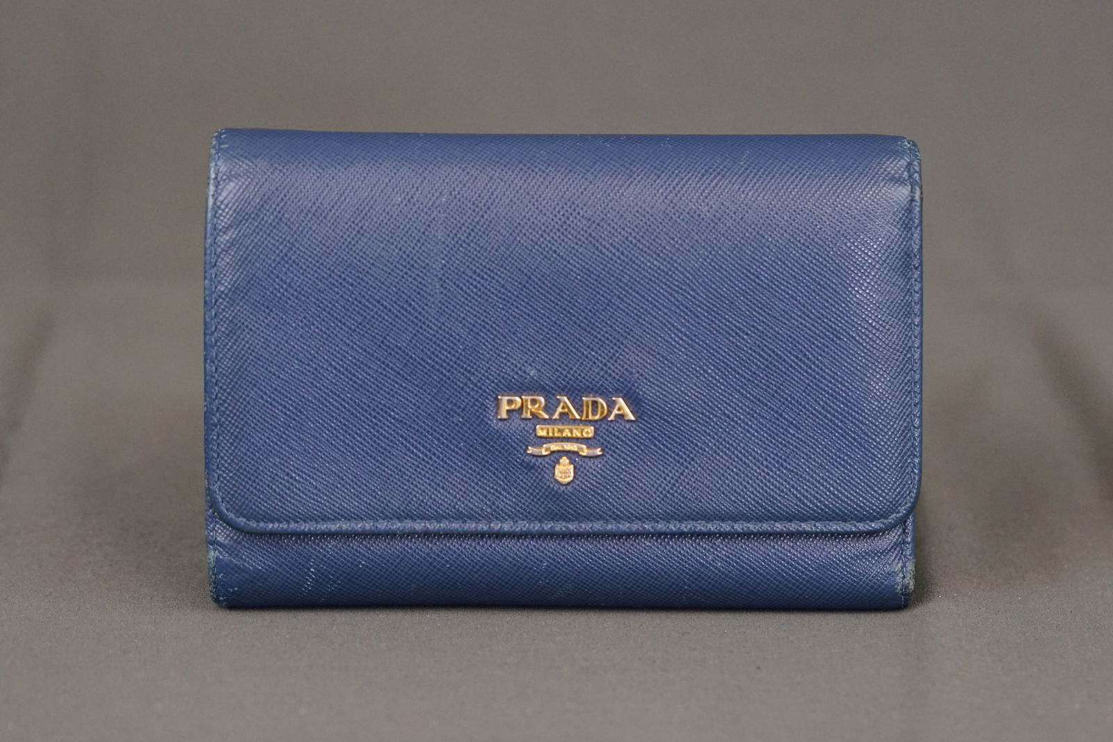 PRADA BLUE LEATHER WALLET COIN PURSE 1MM218: PRADA BLUE LEATHER WALLET COIN PURSE 1MM218, width 11cm, height 8cm, depth 4cm. PLEASE NOTE: *This lot is elected for VAT (20%) on the hammer which will not apply for successful bidders outside of