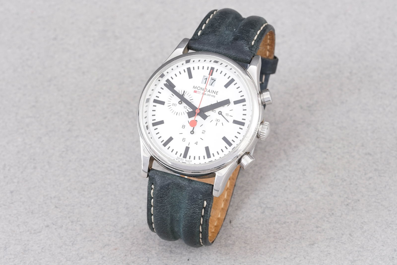 MONDAINE RAILWAY CHRONOGRAPH WRISTWATCH: MONDAINE RAILWAY CHRONOGRAPH WRISTWATCH, this watch is fitted with a circular white dial with hour markers and hands. The 41mm stainless steel case is fitted with a crown and a case back. Inside