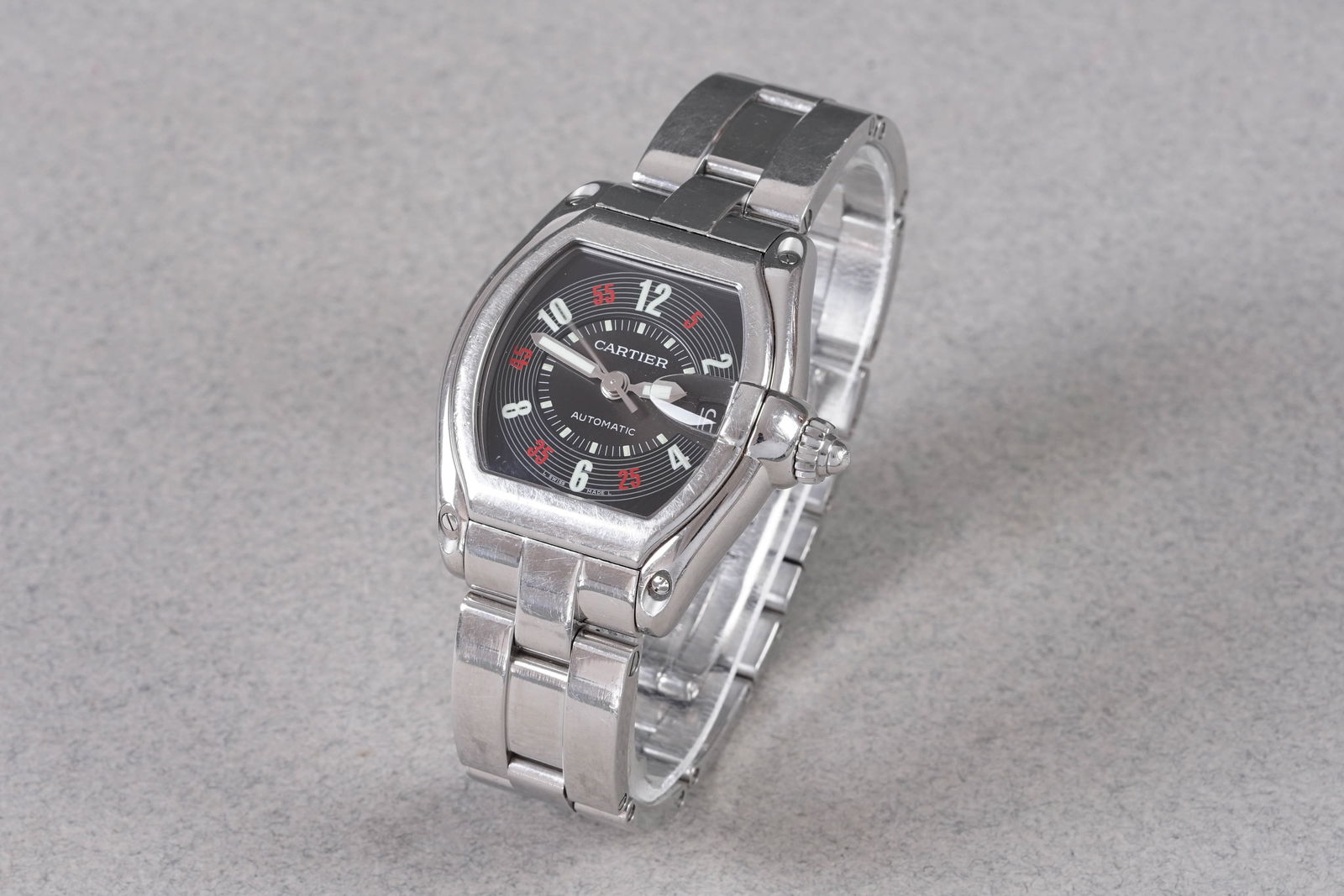 CARTIER ROADSTER DATE AUTOMATIC REF. 2510: CARTIER ROADSTER DATE AUTOMATIC REF. 2510, this watch is a ref. 2510 and is fitted with a barrel shaped black dial with hour markers and hands. The 37mm stainless steel case is fitted with a