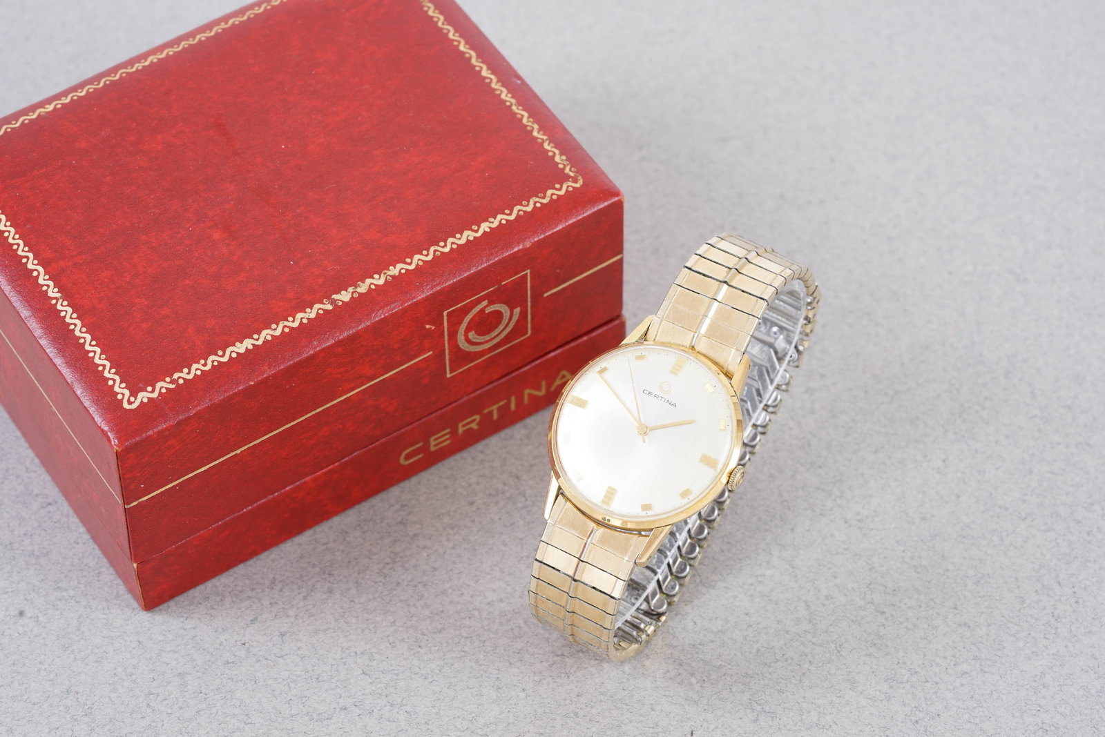 CERTINA WRISTWATCH W/ BOX REF. 5206: CERTINA WRISTWATCH W/ BOX REF. 5206, this watch is a ref. 5206 and is fitted with a round white dial, square gold coloured hour markers and baton hands. The 34 mm gold coloured case is fitted with a