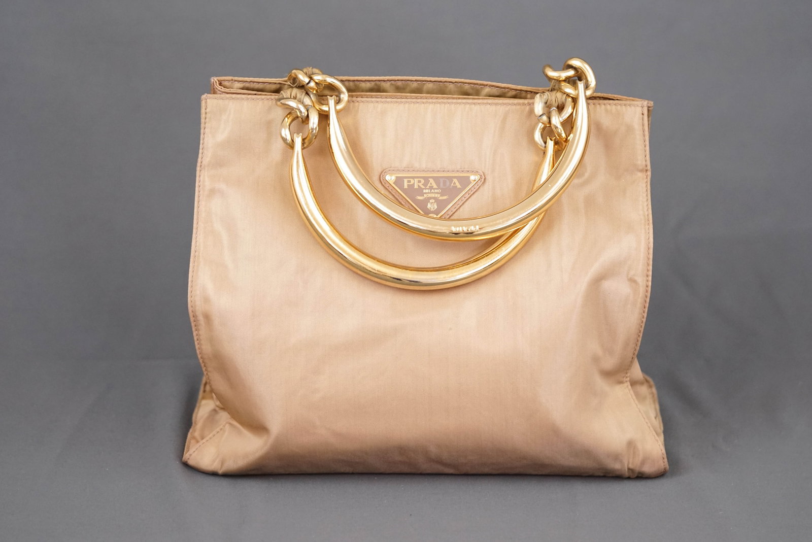 PRADA METAL HANDLE HANDBAG: PRADA METAL HANDLE HANDBAG , nylon with metal handles, width 28cm, height26cm, depth 12cm. If you have any questions regarding this lot please contact us. For further information on our auction,
