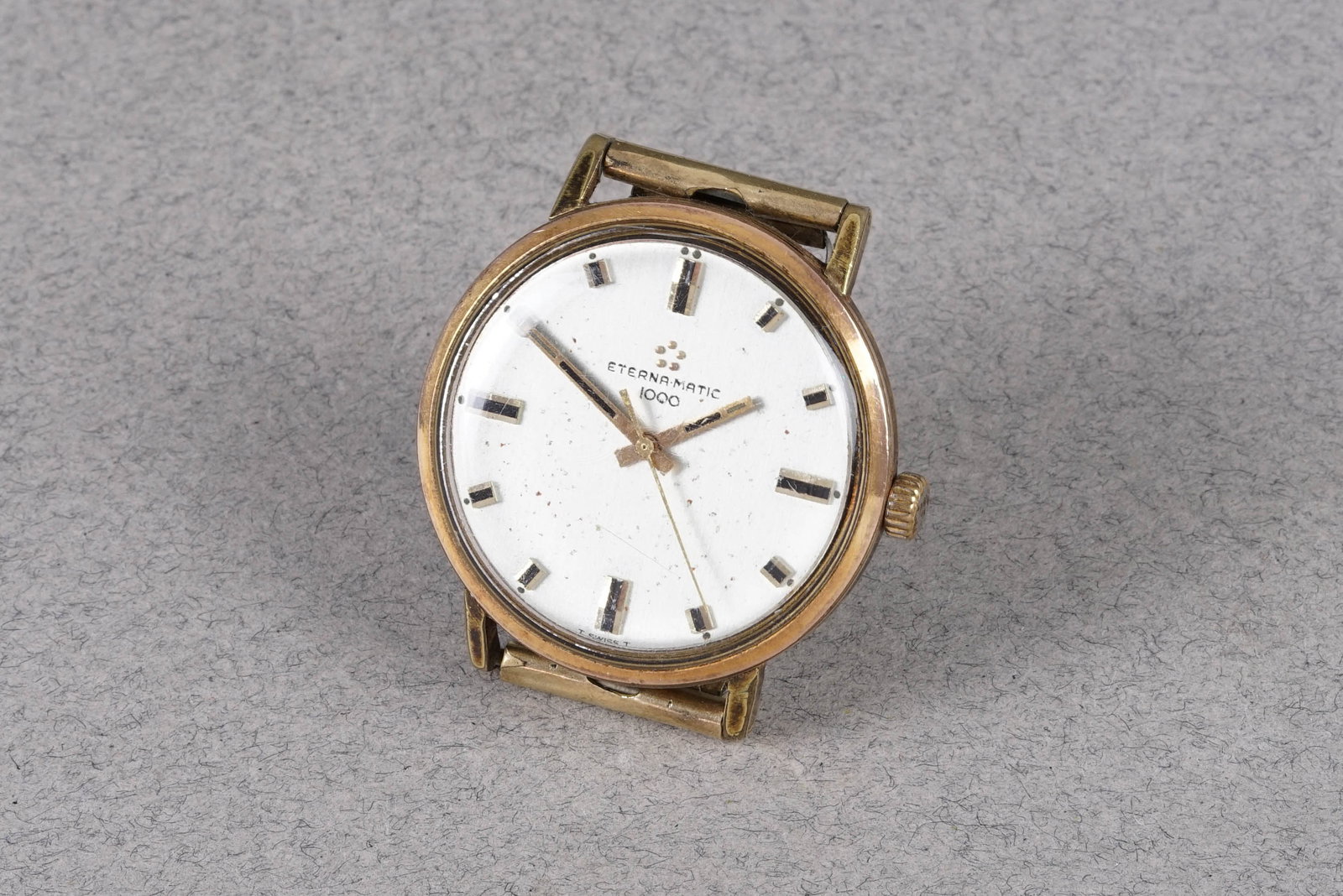 ETERNA-MATIC 1000 GOLD PLATED WRISTWATCH: ETERNA-MATIC 1000 GOLD PLATED WRISTWATCH, this watch is fitted with a circular patina dial with applied hour markers and hands. The 34mm gold plated case is fitted with a crown and a case back.