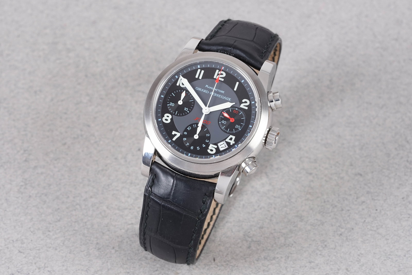 GIRARD PERREGAUX F300 FERRARI CHRONOGRAPH REF. 8020: GIRARD PERREGAUX F300 FERRARI CHRONOGRAPH REF. 8020, this watch is a ref. 8020 and is fitted with a round black dial with a date window, number hour markers and pencil style hands. The 38mm steel case