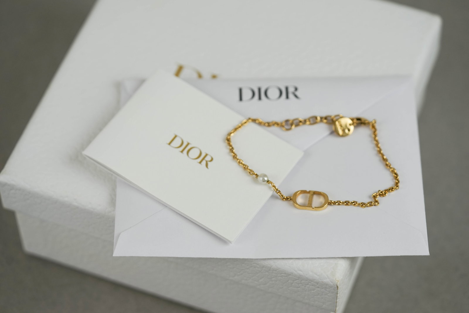 DIOR 30 MONTAIGNE GOLD PLATED BRACELET W/ BOX & POUCH: DIOR 30 MONTAIGNE GOLD PLATED BRACELET W/ BOX & POUCH, dimensions 16cm total length approx. Comes with box and papers. If you have any questions regarding this lot please contact us. For further