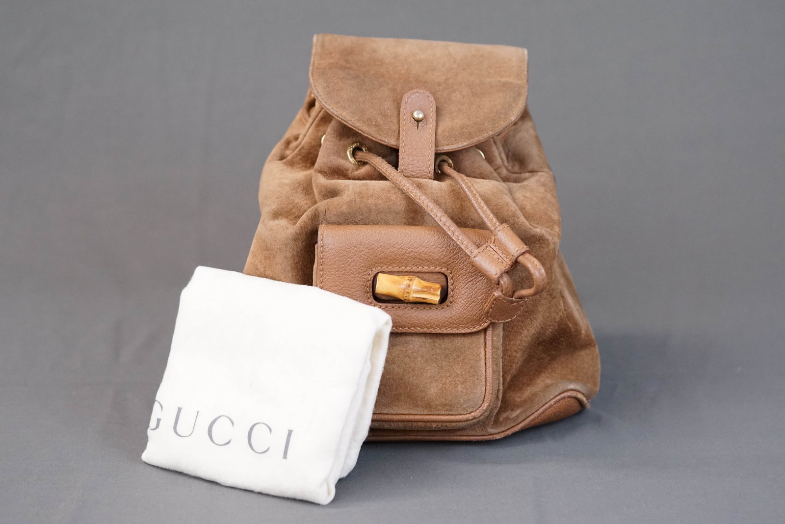 GUCCI BROWN SUEDE LEATHER BAMBOO BACKPACK: GUCCI BROWN SUEDE LEATHER BAMBOO BACKPACK, width 21cm, height 23cm, depth 7cm. With dust cover. If you have any questions regarding this lot please contact us. For further information on our auction,