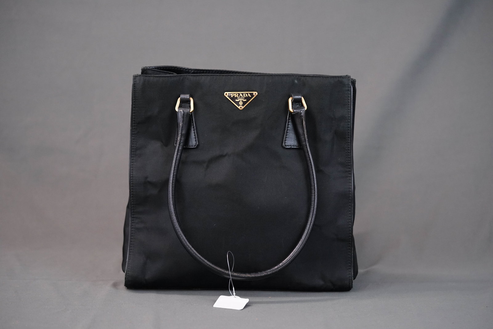 PRADA POCONO BLACK NYLON HANDBAG: PRADA POCONO BLACK NYLON HANDBAG, width 27cm, height 26cm, depth 6cm. If you have any questions regarding this lot please contact us. For further information on our auction, please refer to our T &