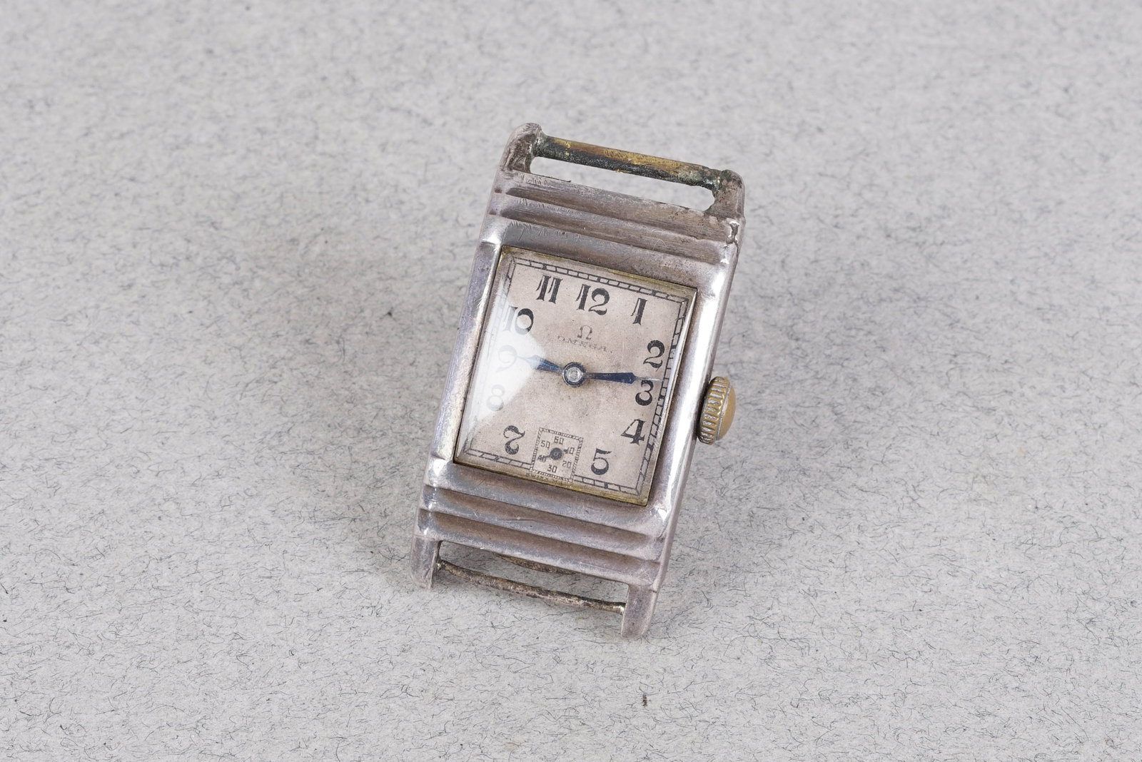 OMEGA SILVER TANK STYLE WRISTWATCH CIRCA 1930: OMEGA SILVER TANK STYLE WRISTWATCH CIRCA 1930, this watch is fitted with a patina white dial with sub dial, Breguet style hour markers and pencil hands. The 23mm steel case is fitted with a crown and