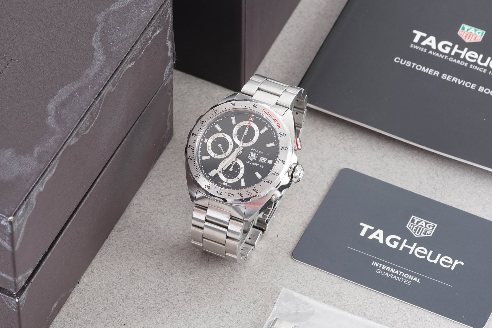 TAG HEUER FORMULA 1 CALIBRE 16 AUTOMATIC CHRONOGRAPH W/ BOX REF. CAZ2010: TAG HEUER FORMULA 1 CALIBRE 16 AUTOMATIC CHRONOGRAPH W/ BOX REF. CAZ2010, this watch is a ref. CAZ2010 and is fitted with a circular black triple register dial with a date window, hour markers and han