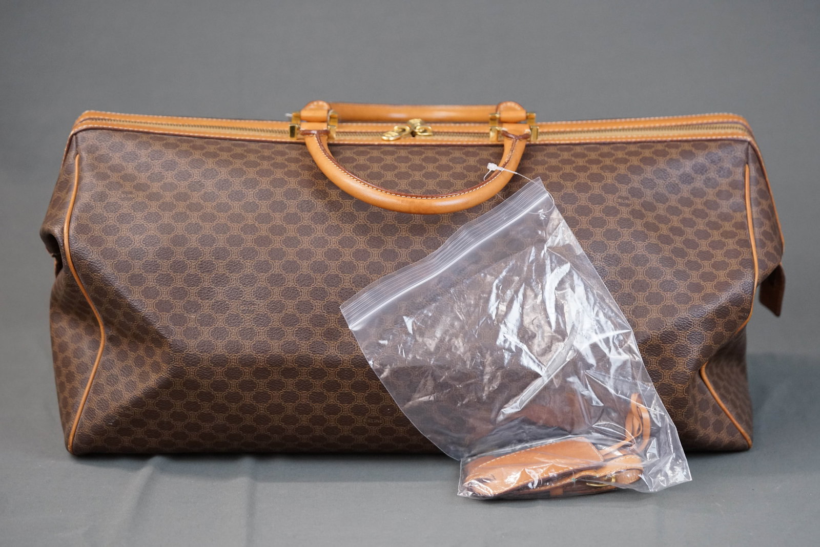 CELINE MACADAM BOSTON BAG: CELINE MACADAM BOSTON BAG, width 49cm, height 27cm, depth 19cm with padlock and key If you have any questions regarding this lot please contact us. For further information on our auction, please
