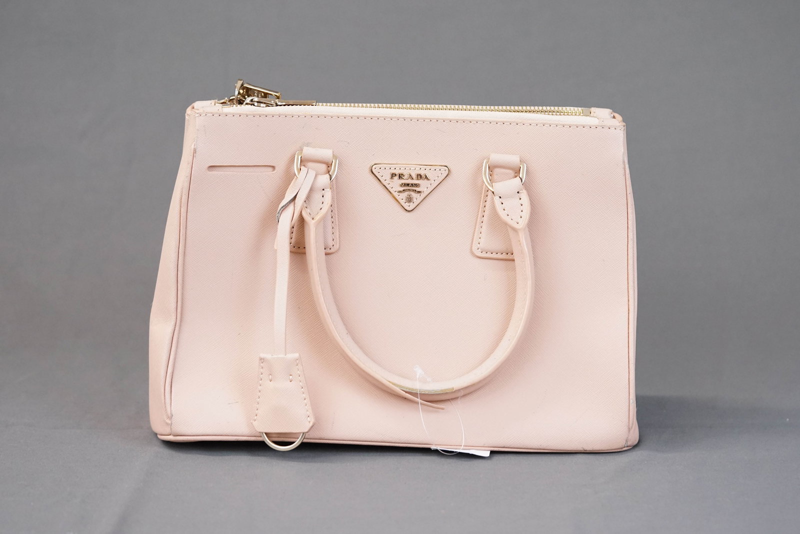 PRADA SAFFIANO CLOCHETTE PINK LEATHER: PRADA SAFFIANO CLOCHETTE PINK LEATHER, width 29cm, height 20cm, depth 19cm. If you have any questions regarding this lot please contact us. For further information on our auction, please refer to our 