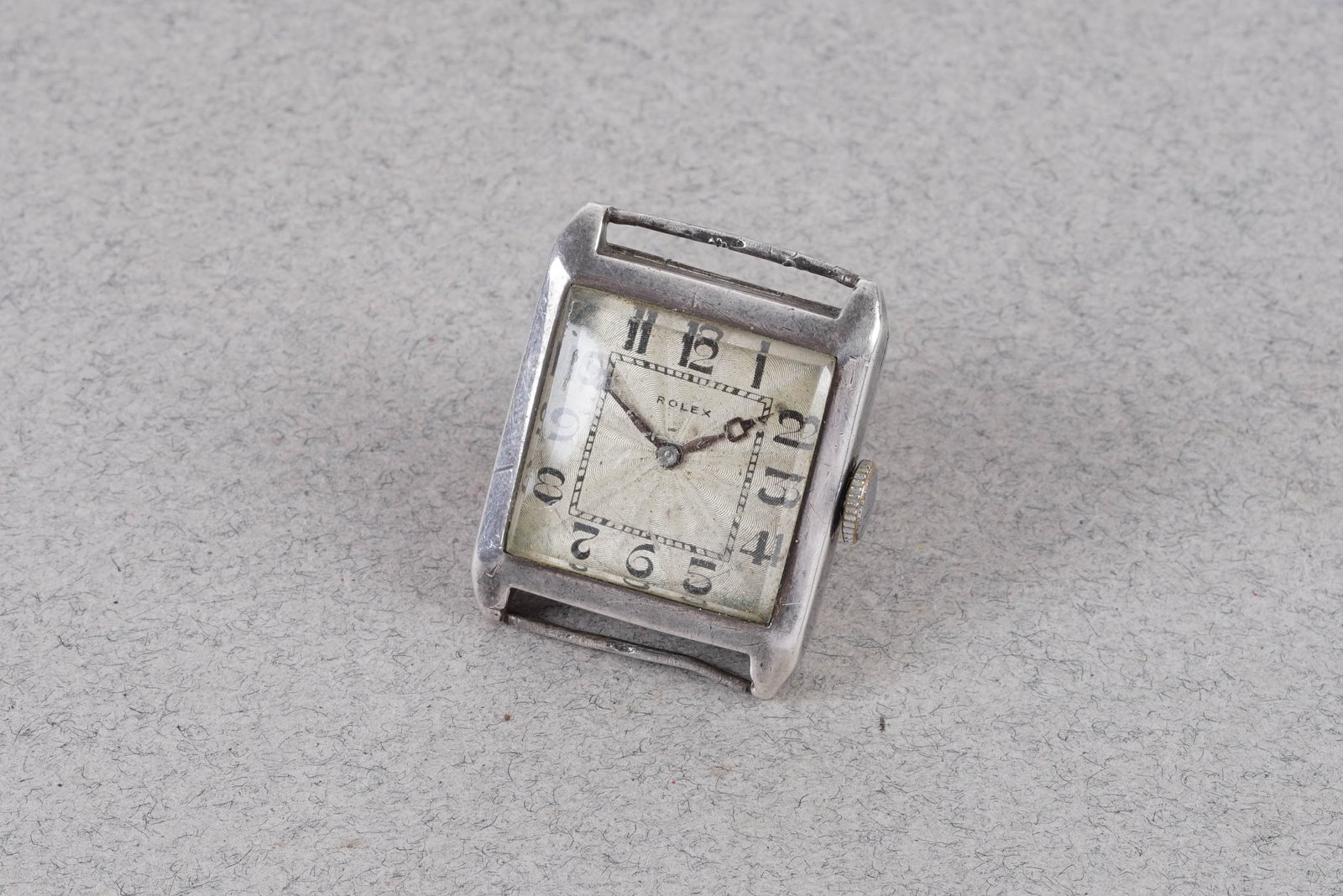 ROLEX 925 STERLING SILVER TANK WRISTWATCH REF. 580 CIRCA 1929: This watch is a ref. 580 and is fitted with a square white dial, numbered hour markers and breguet hands. The 26mm silver case is fitted with a crown and a snap case back. Inside is a manual wind