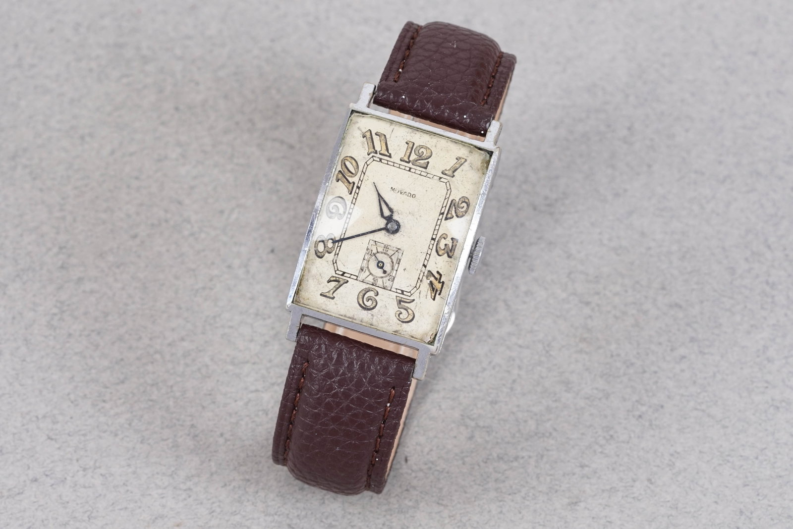 MOVADO OVERSIZE TANK STYLE WRISTWATCH: MOVADO OVERSIZE TANK STYLE WRISTWATCH, this watch is fitted with a deco dial with sub seconds, Breguet style numerical hour markers and hands. The 36mm steel case is fitted with a crown and a snap