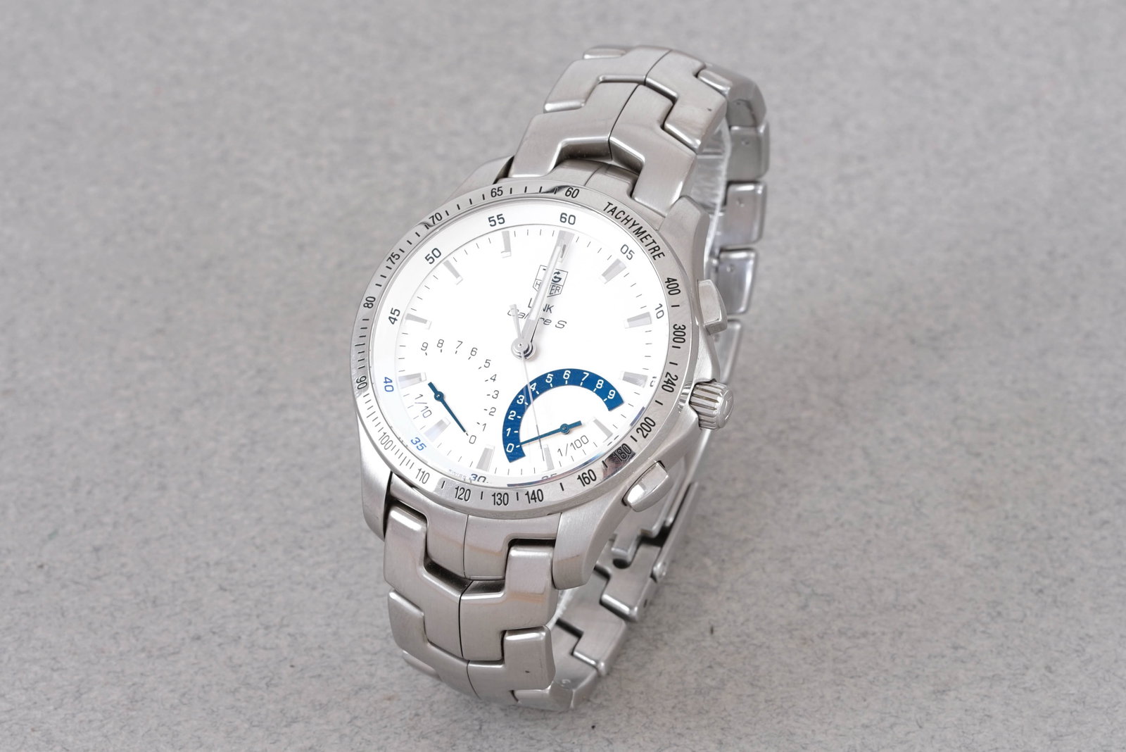 TAG HEUER LINK CALIBRE S WRISTWATCH REF. CJF7111: TAG HEUER LINK CALIBRE S WRISTWATCH REF. CJF7111, this watch is a ref. CJF7111 and is fitted with a circular white dial with applied silver hour markers and silver hands. The 41mm stainless steel