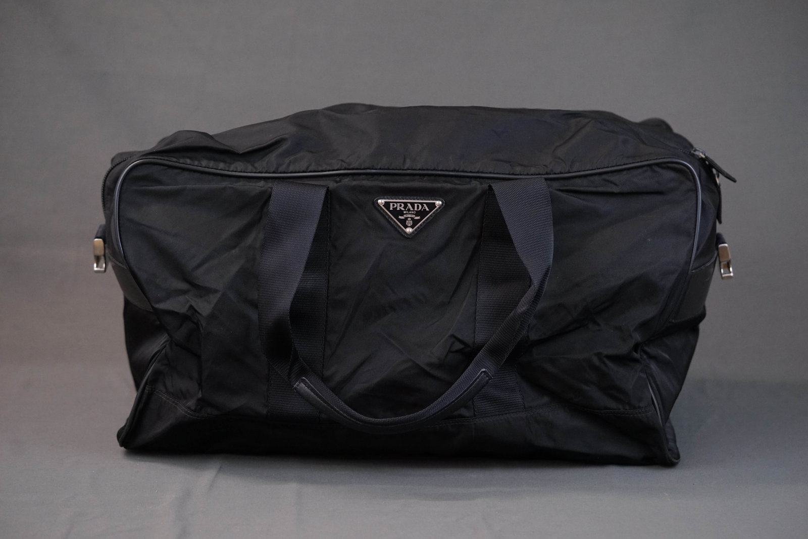 PRADA POCONO BOSTON BAG BLACK NYLON: PRADA POCONO BOSTON BAG BLACK NYLON, width cm, height cm, depth cm. If you have any questions regarding this lot please contact us. For further information on our auction, please refer to our T &