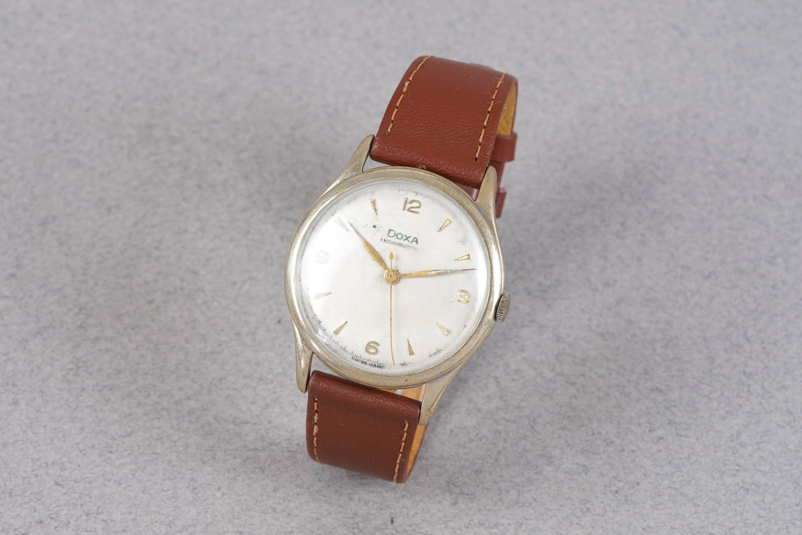 DOXA OVERSIZE ANTIMAGNETIC WRISTWATCH: DOXA OVERSIZE ANTIMAGNETIC WRISTWATCH, this watch is fitted with a white dial, mixed hour markers and dauphine hands. The 38mm steel and plated case is fitted with a crown and a snap case back. Inside