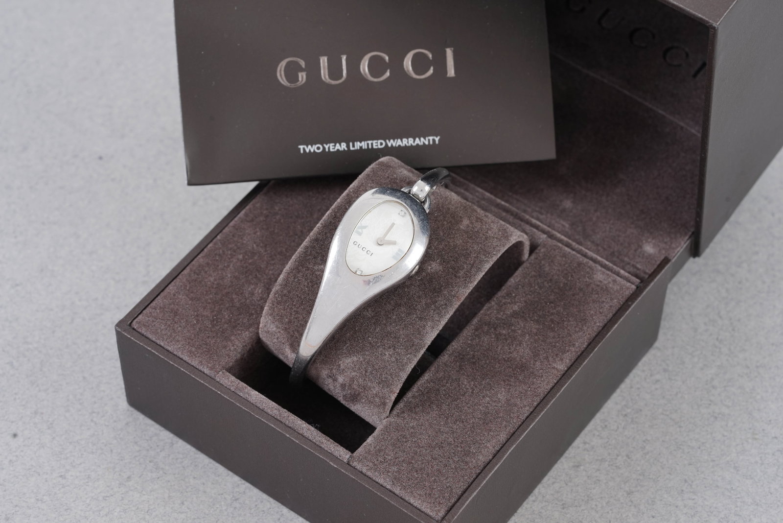 GUCCI DIAMOND SET BANGLE WATCH W/ BOX REF. 103: GUCCI DIAMOND SET BANGLE WATCH W/ BOX REF. 103, this watch is a ref.103 and is fitted with an oval white diamond set dial with, diamond hour markers and baton hands. The 22 mm oval steel case is