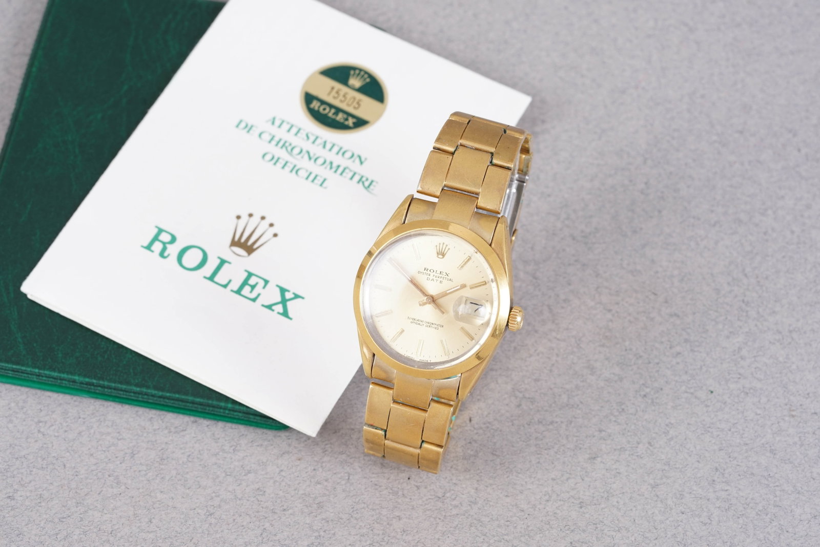 ROLEX OYSTER PERPETUAL DATE W/ GUARANTEE PAPERS REF. 15505 CIRCA 1963: ROLEX OYSTER PERPETUAL DATE W/ GUARANTEE PAPERS REF. 15505 CIRCA 1963 'golden egg', this watch is fitted with a round gold coloured dial with date, baton hour markers and hands. The 35mm plated case
