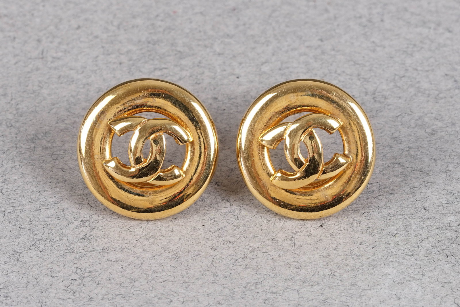 CHANEL EARRINGS: Channel gold coloured CC logo clip on earrings, approx. dimensions 2.1cm, approx. If you have any questions regarding this lot please contact us. For further information on our auction, please refer