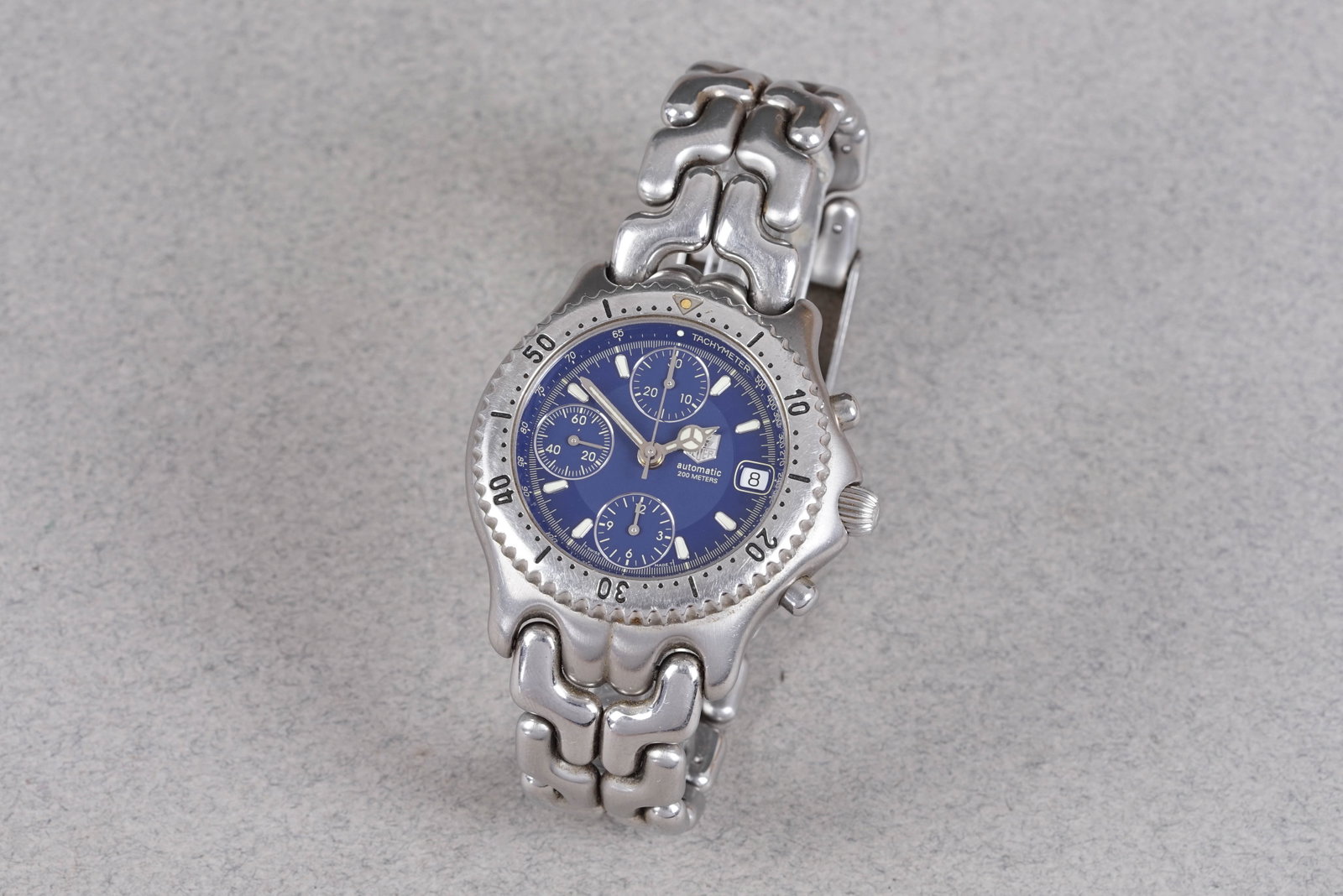 TAG HEUER LINK AUTOMATIC CHRONOGRAPH W/ BOX & PAPERS REF. CG2111-R0: TAG HEUER LINK AUTOMATIC CHRONOGRAPH W/ BOX & PAPERS REF. CG2111-R0, and is fitted with a circular blue dial with 3 sub dials and date window, baton hour markers and Mercedes hands. The 40mm